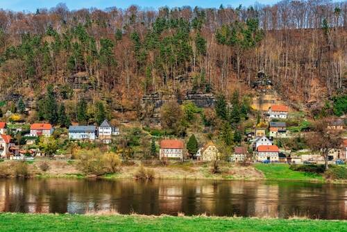 Panorama view of houses on the Elbe river side near Saxon Switzerland National Park in Saxony, Germany